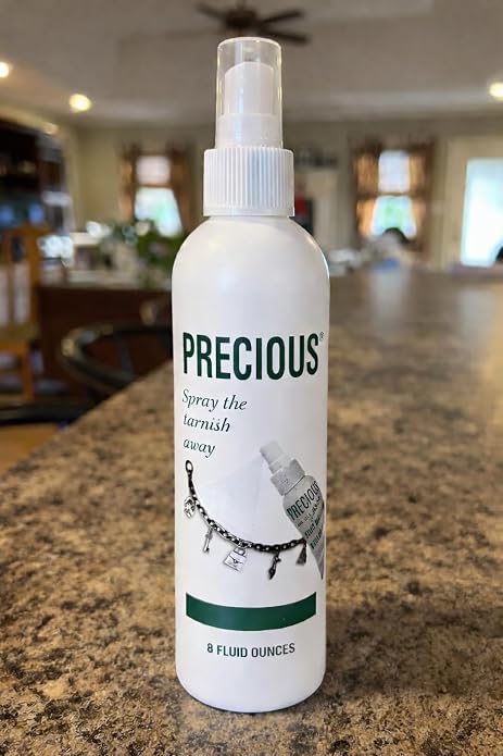 White spray bottle labeled 'Precious' on a kitchen counter
